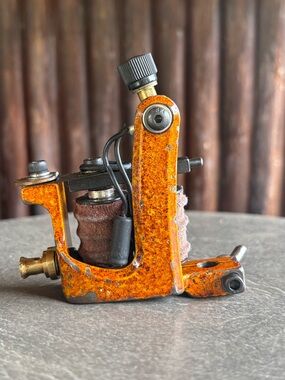 Orange distressed vintage style Coil Tattoo Machine.